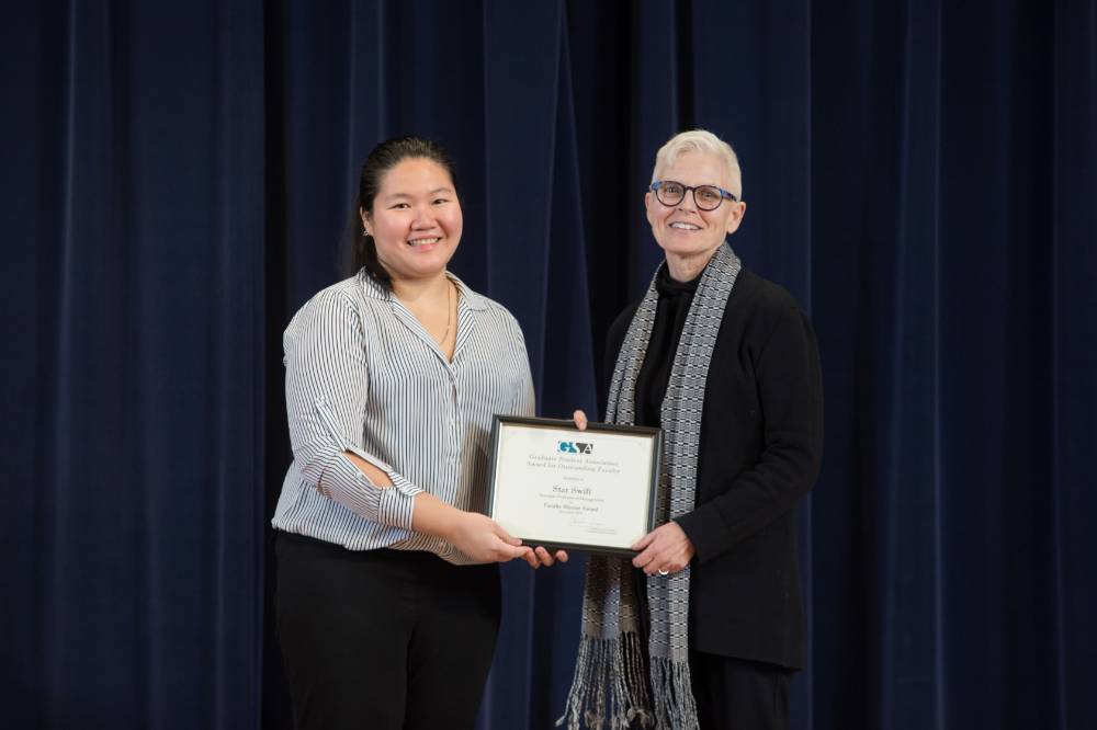 GSA President posing for a photo with a professor receiving an award